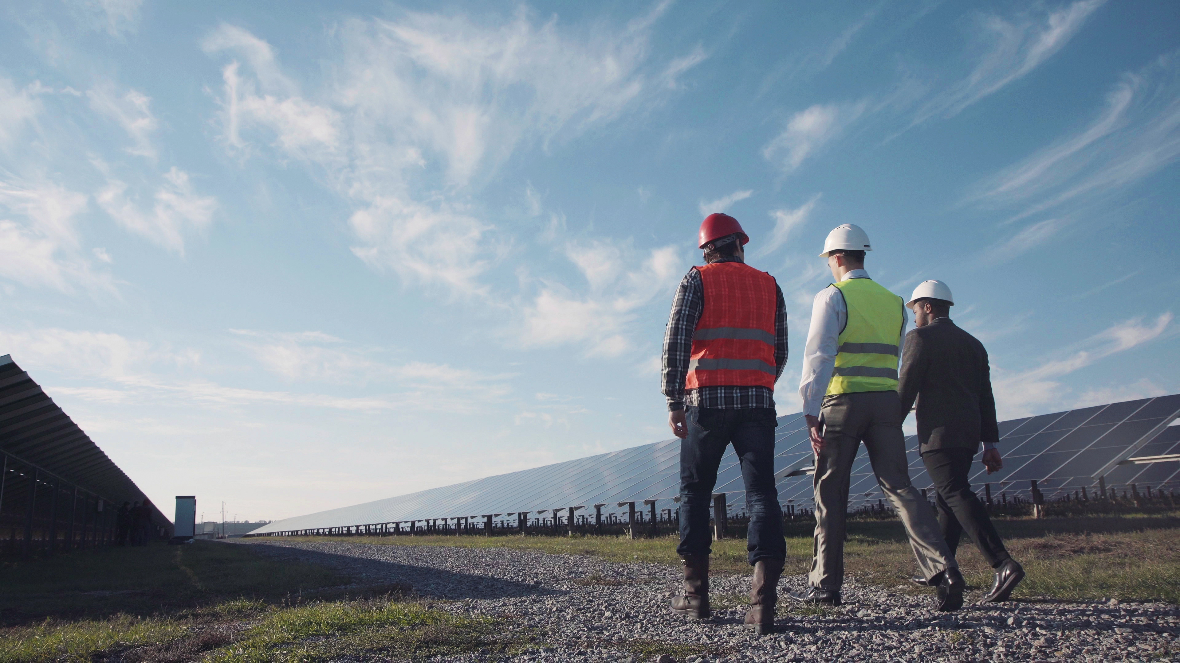 men in solar panel field