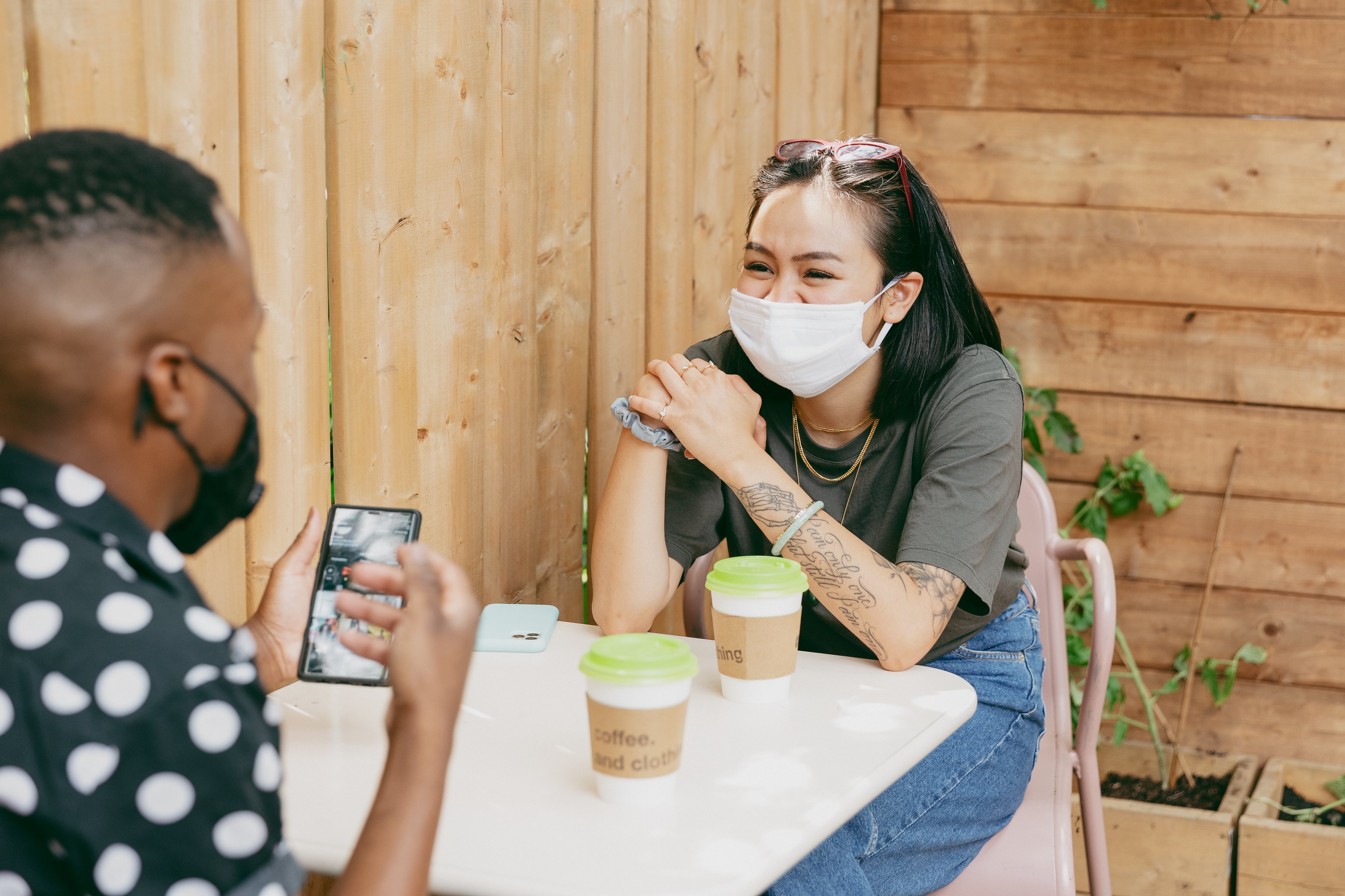 two people enjoying a socially-distanced coffee