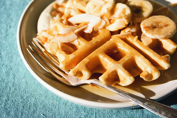 Vegan waffles topped with banana