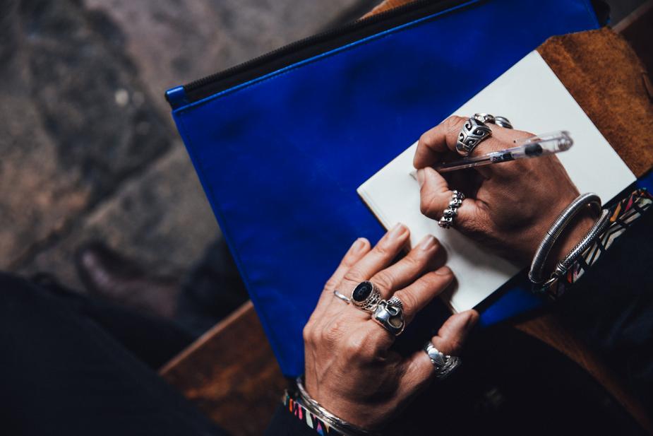 hands with rings writing a letter