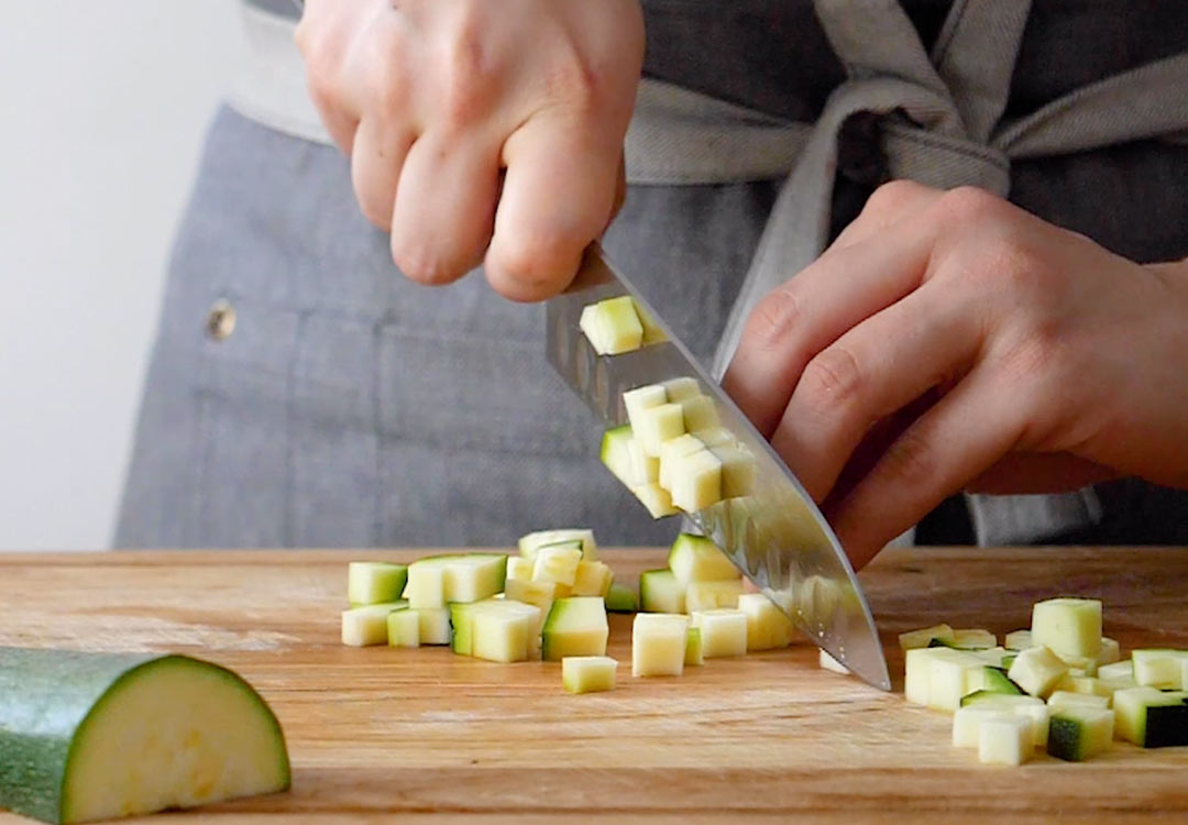 chef chopping a courgette