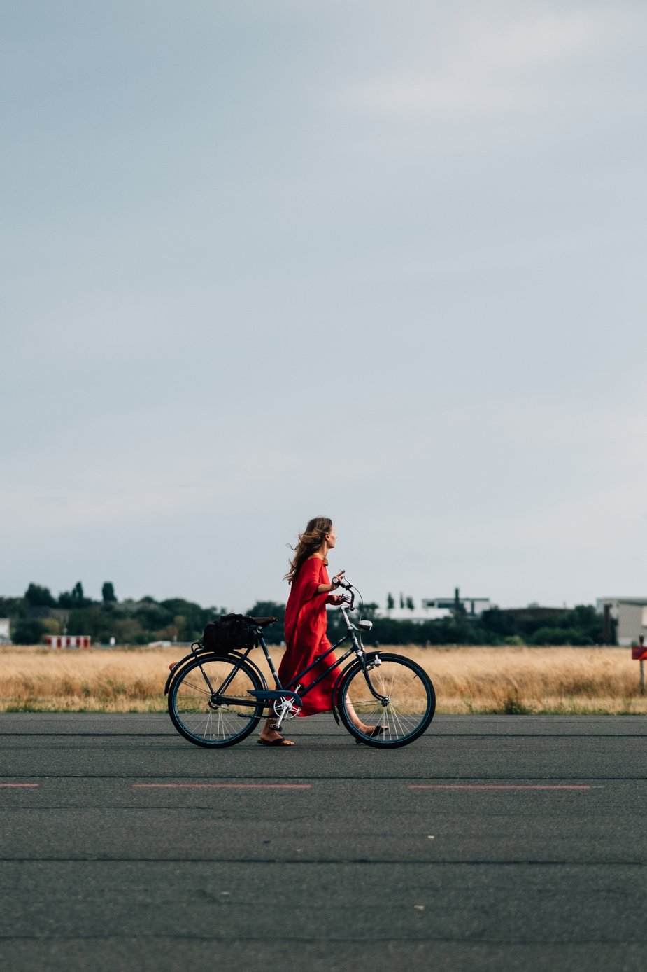 woman in red with bike