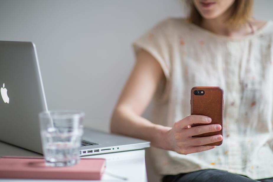 woman on laptop and phone