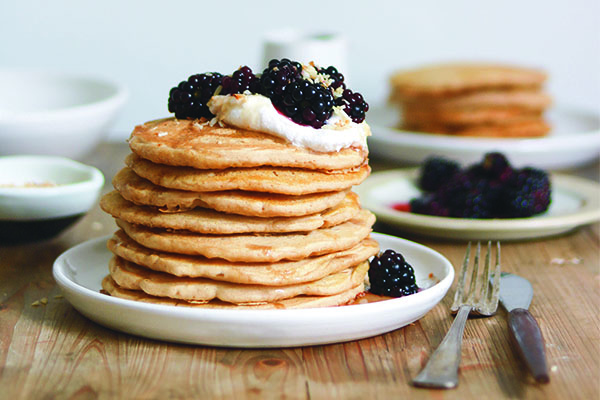Stack of vegan pancakes topped with blackberries