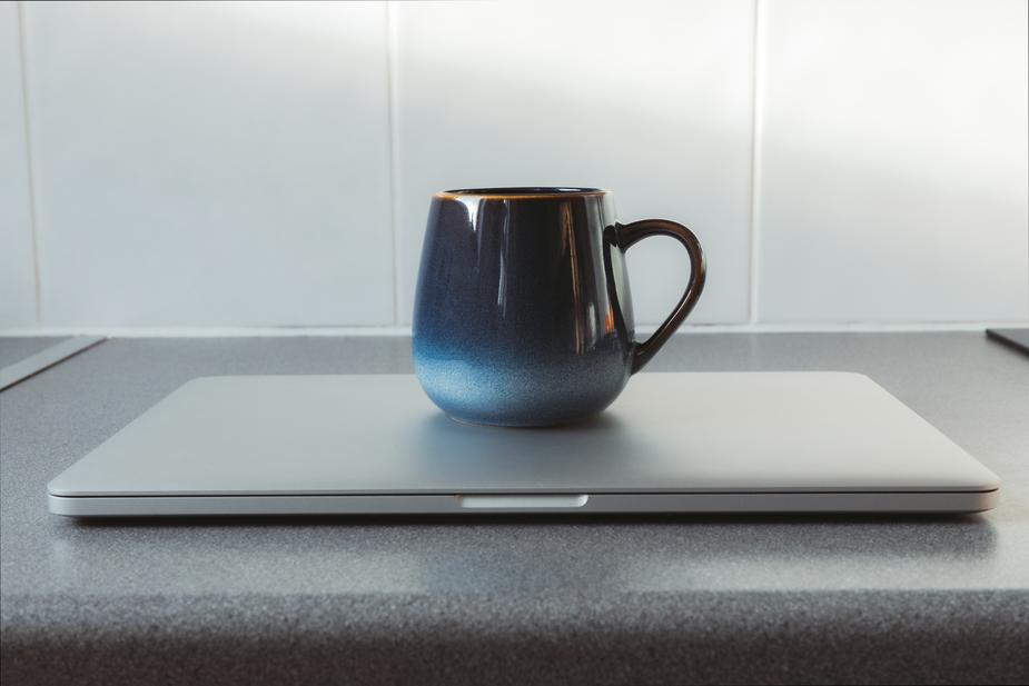 mug on closed laptop