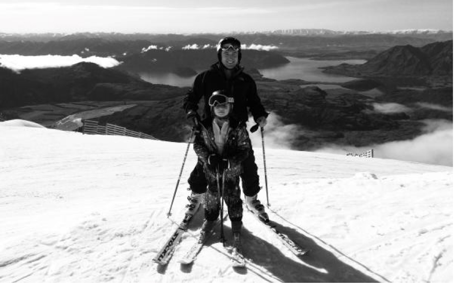 alt=Founder of NZ Alpine Trust Cameron Wilson on Coronet Peak with his daughter