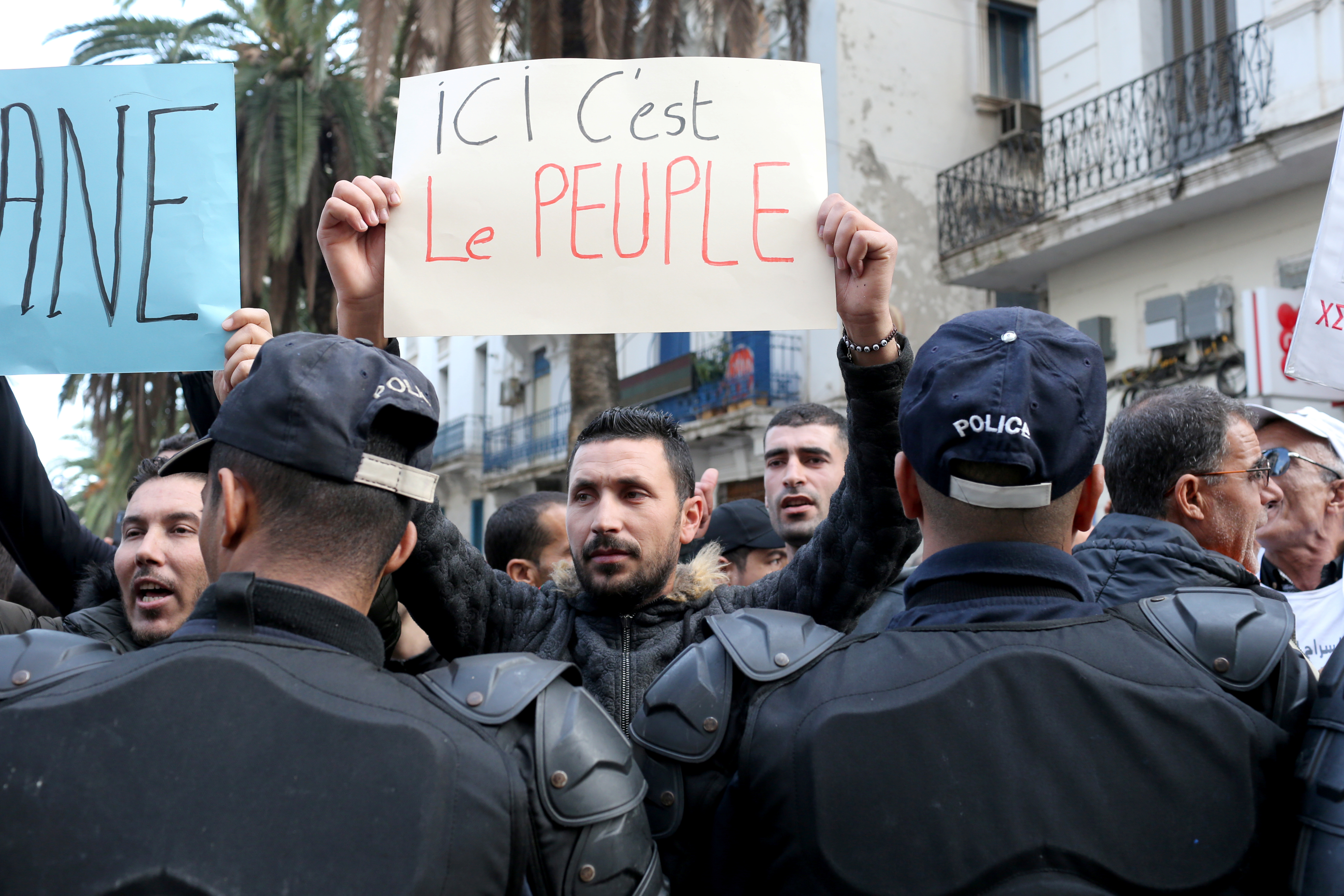 A demonstrator holds a placard during an anti-government rally in Algiers, Algeria December 27, 2019. REUTERS/Ramzi Boudina