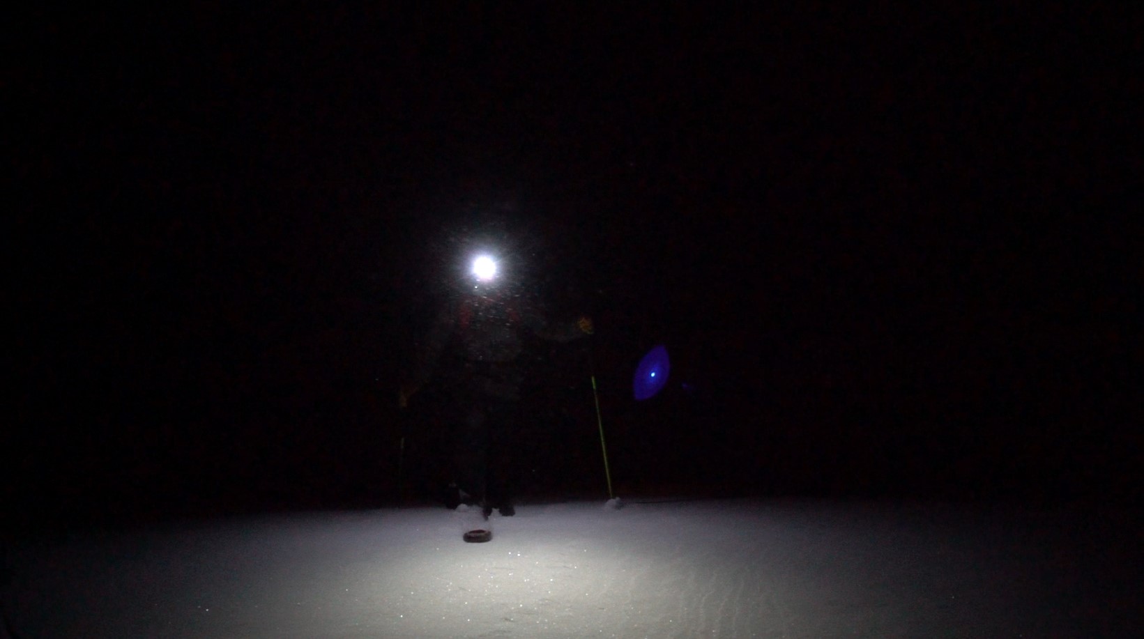 night time photo of skier with a headlamp