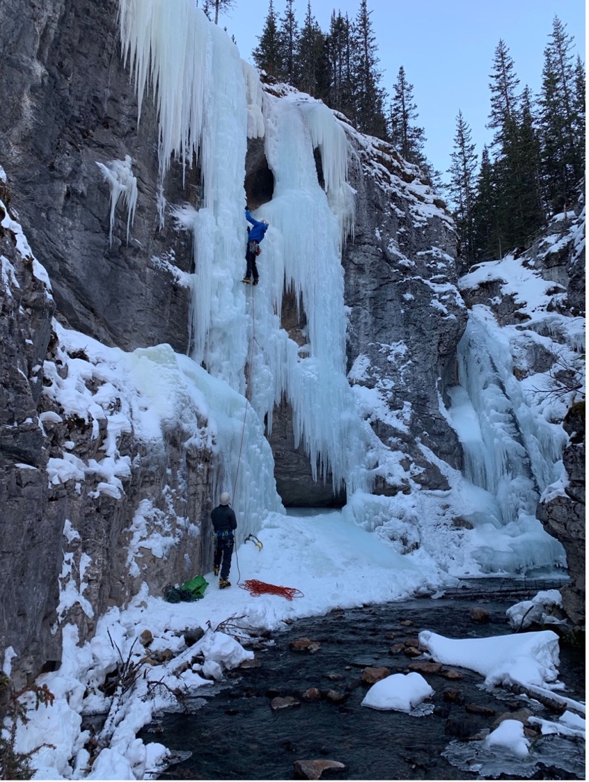 Image shows an ice climber ascending Tasting Fear