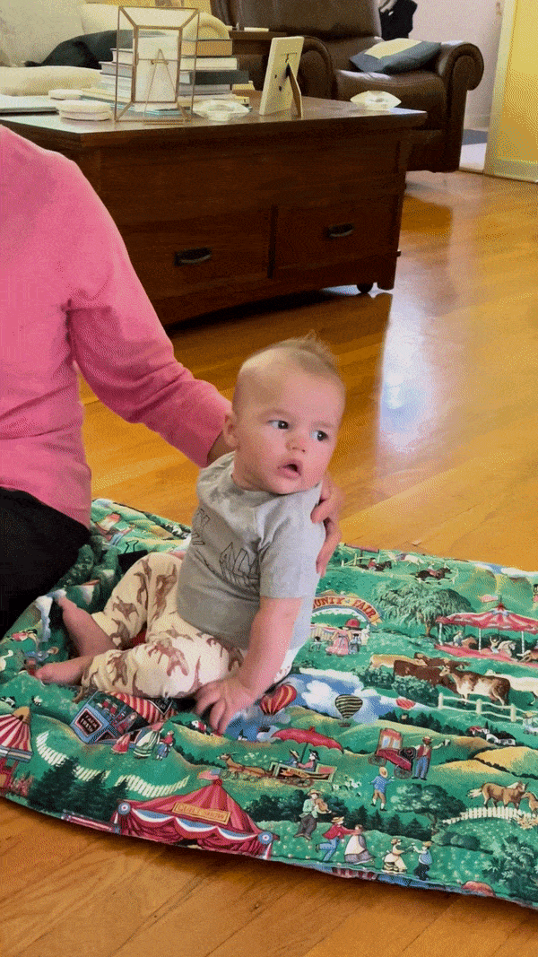Gif of baby falling from sitting position onto face