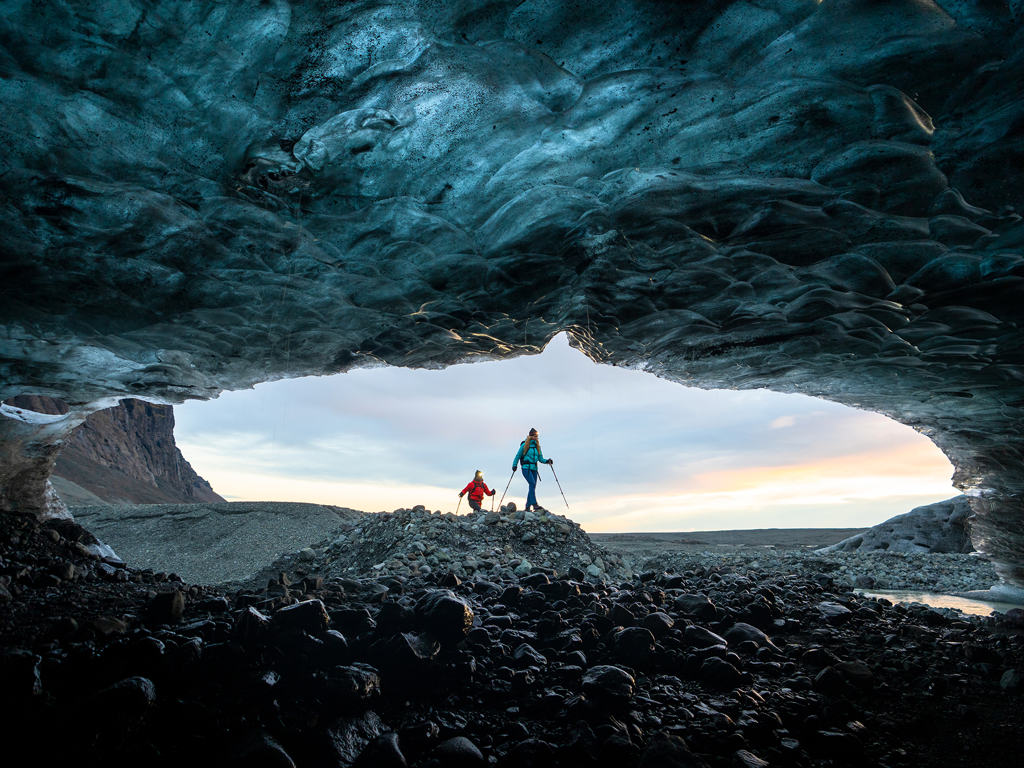 Two hikers about to enter an ice cave in Iceland. 