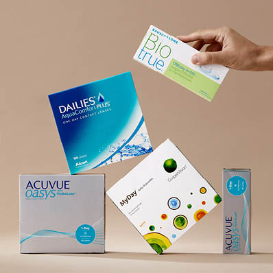A stack of contact lens boxes from Acuvue, Dailies, MyDay and BioTrue.