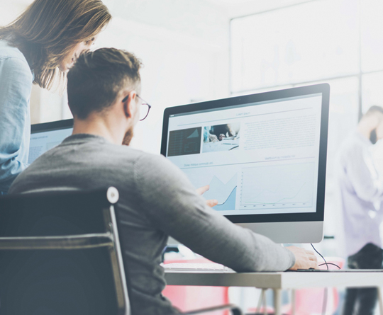 coworkers in front of monitor