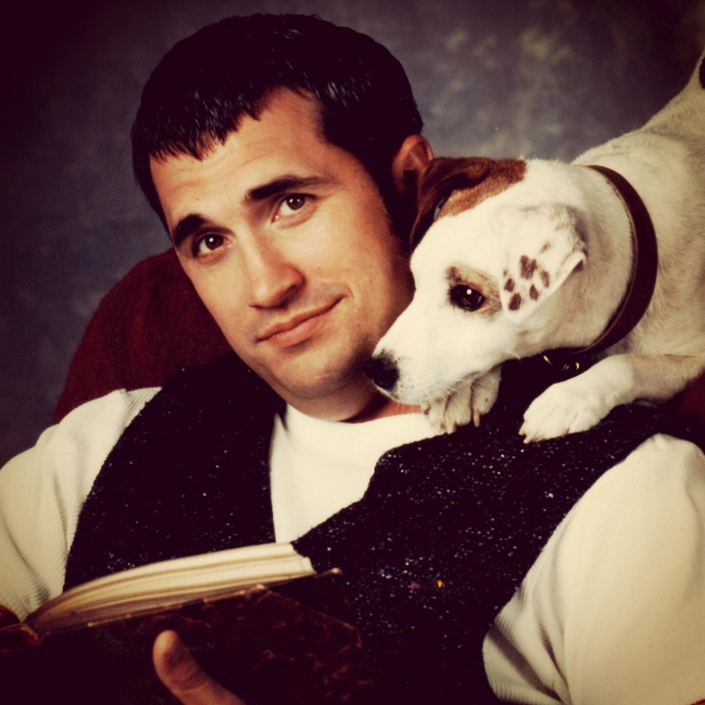 Larry Brantley and Soccer the dog reading a book