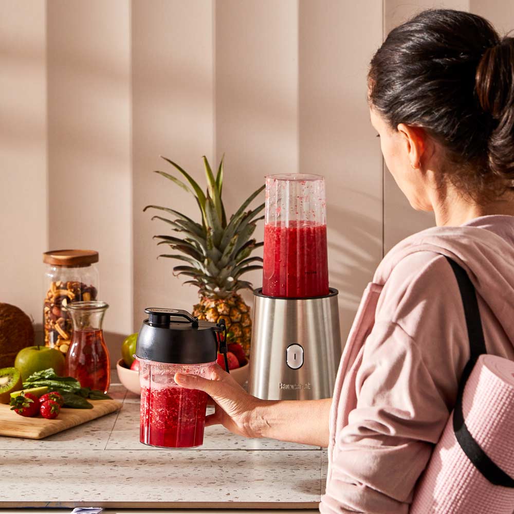 Baccarat The Power Blast Blender. Your guide to Back to school - House Blog. Woman in gym gear picking up berry smoothie.
