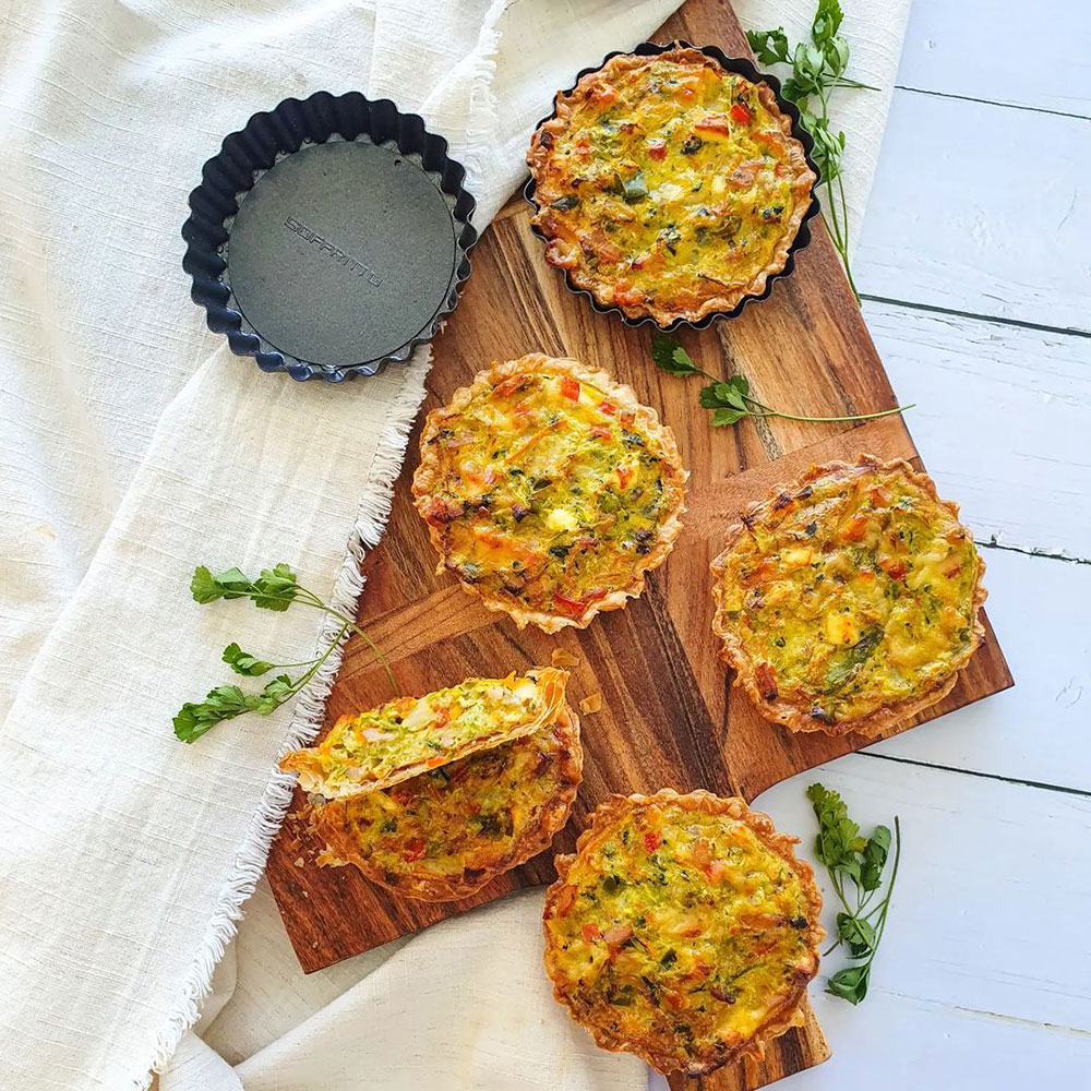 Mini Quiche Tarts recipe - House Blog. mini quiches with quiche tins on serving board.