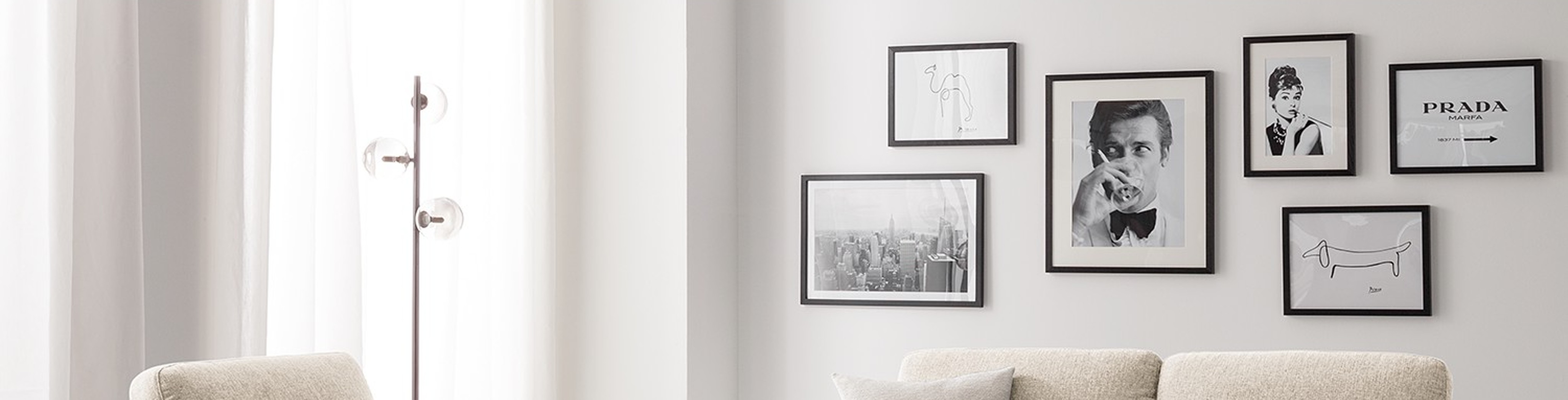 Compositie van zwart-wit-foto's in zwarte lijsten tegen witte wand