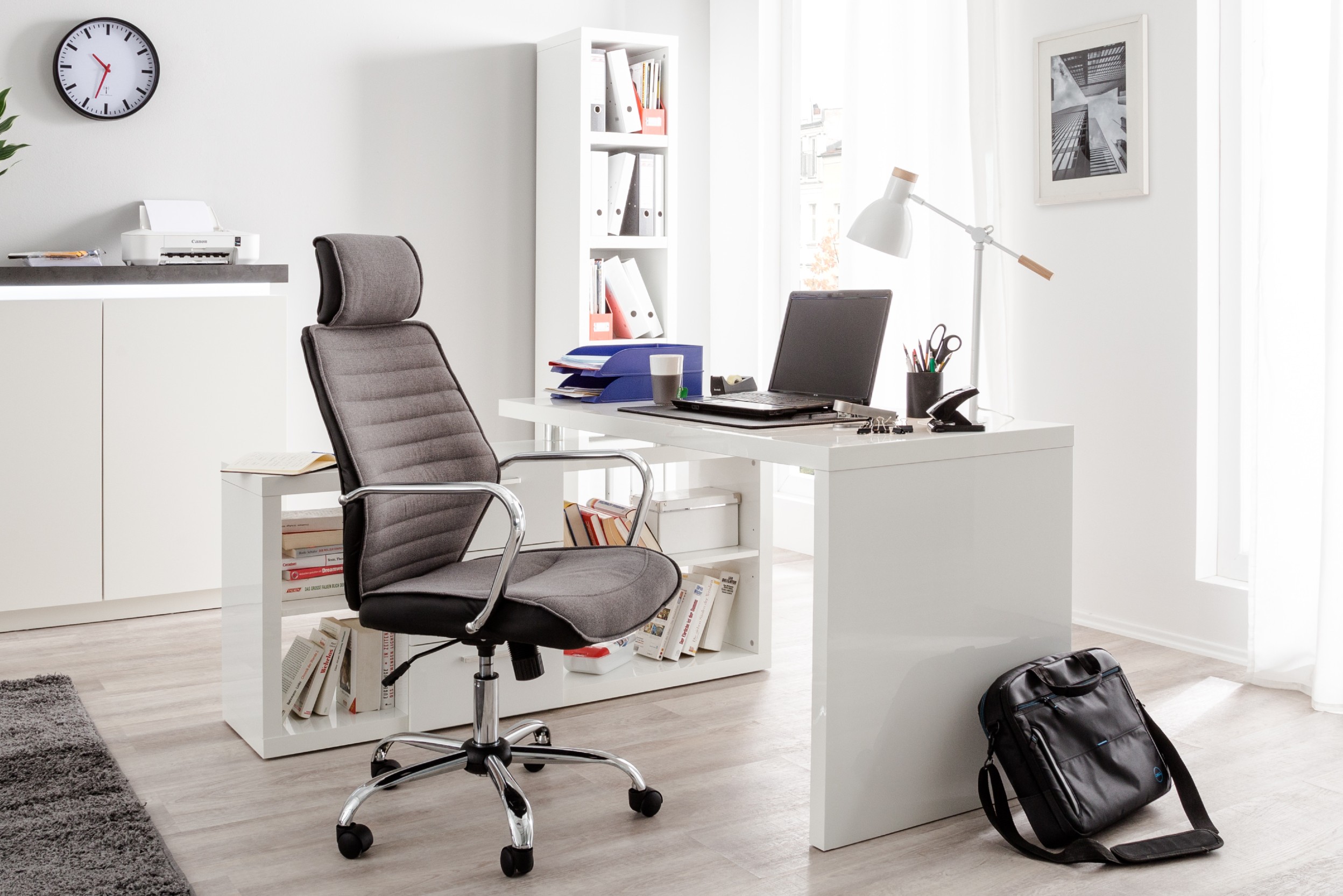 Arbeitsplatz mit ergonomischem Schreibtischstuhl und weißer Schreibtisch