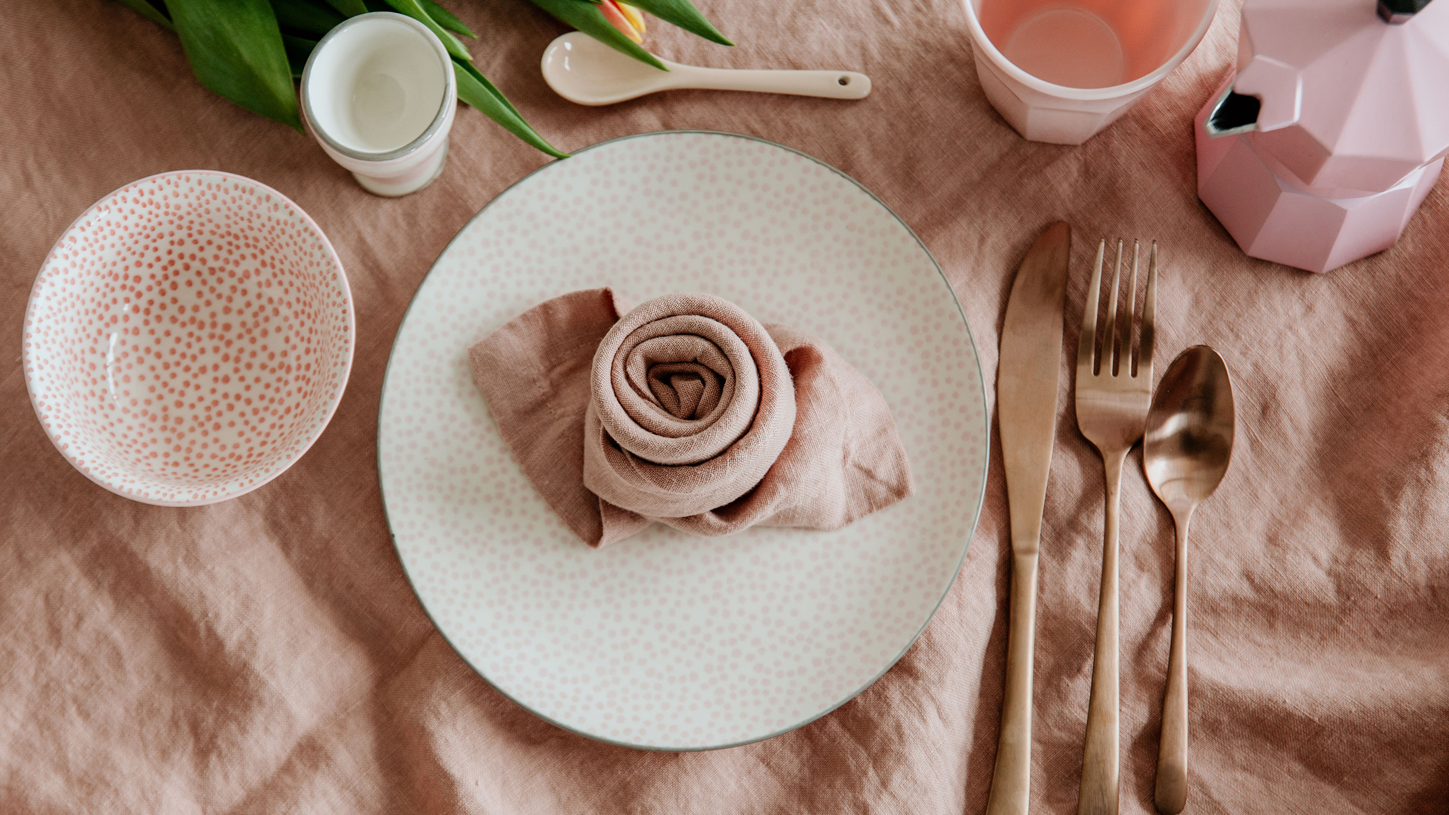 Serviette zur Rose falten (Marke des Geschirrs und der Tischwäsche im Hintergrund: Butlers).