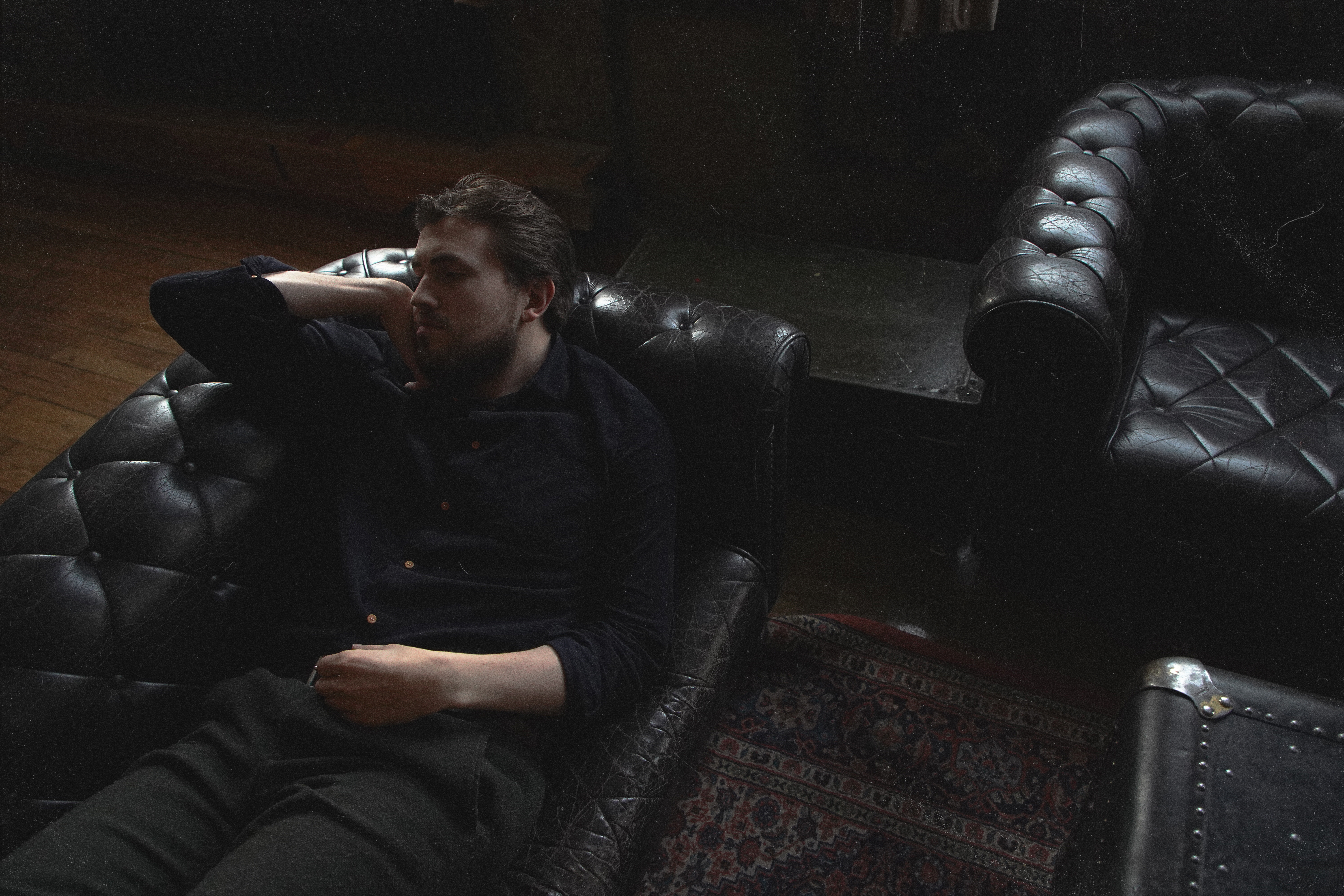 Icelandic artist Axel Flovent lying in a sofa