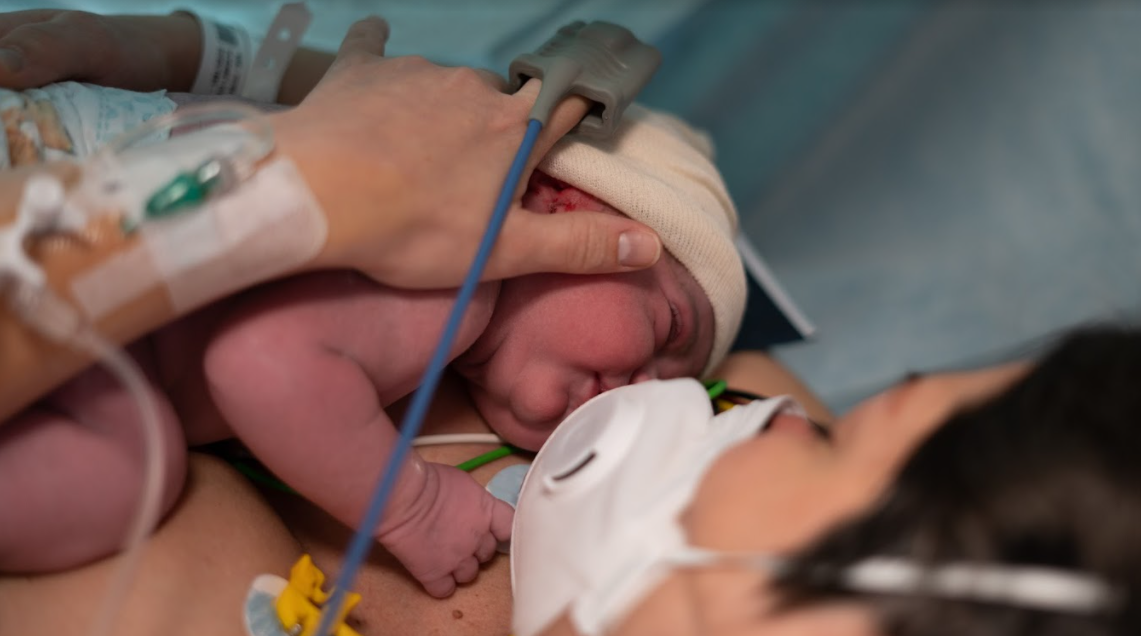 Mother holding her newborn baby in a hospital