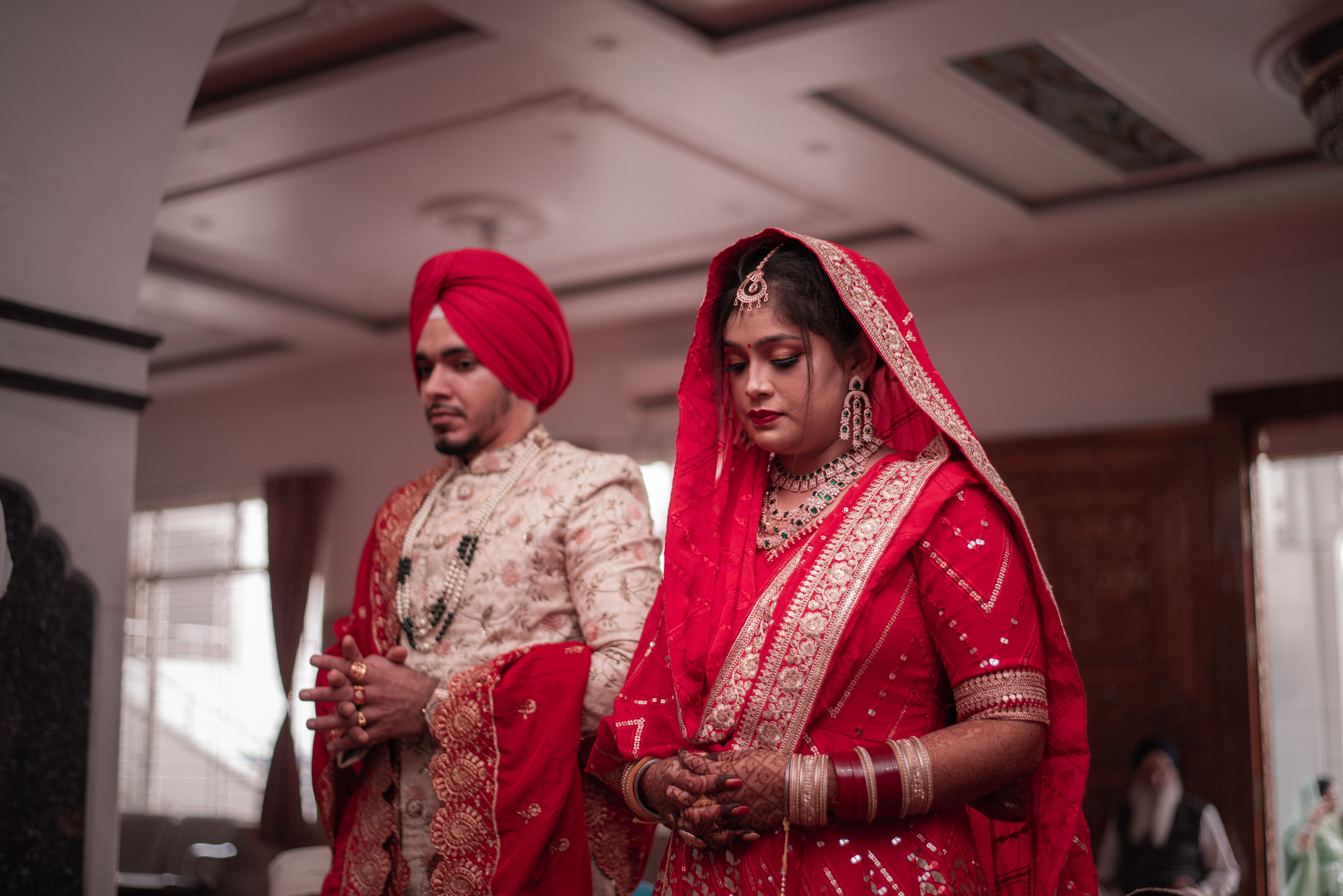 Sikh Bride and groom praying in gurdwara