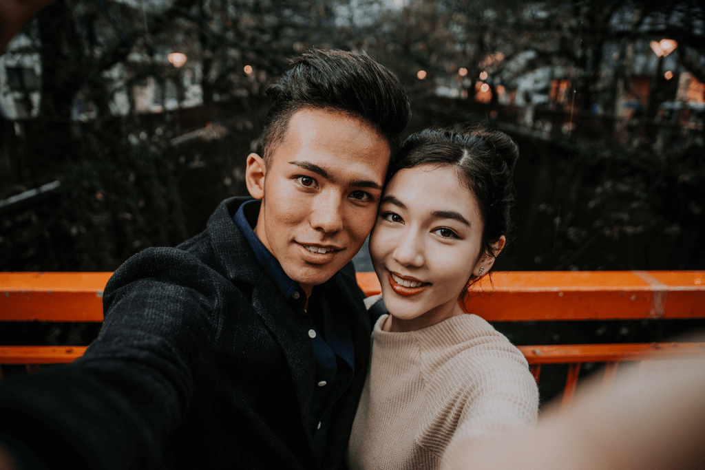 A couple poses for a selfie on a bridge at a popular date spot for Valentine's Day in Japan.