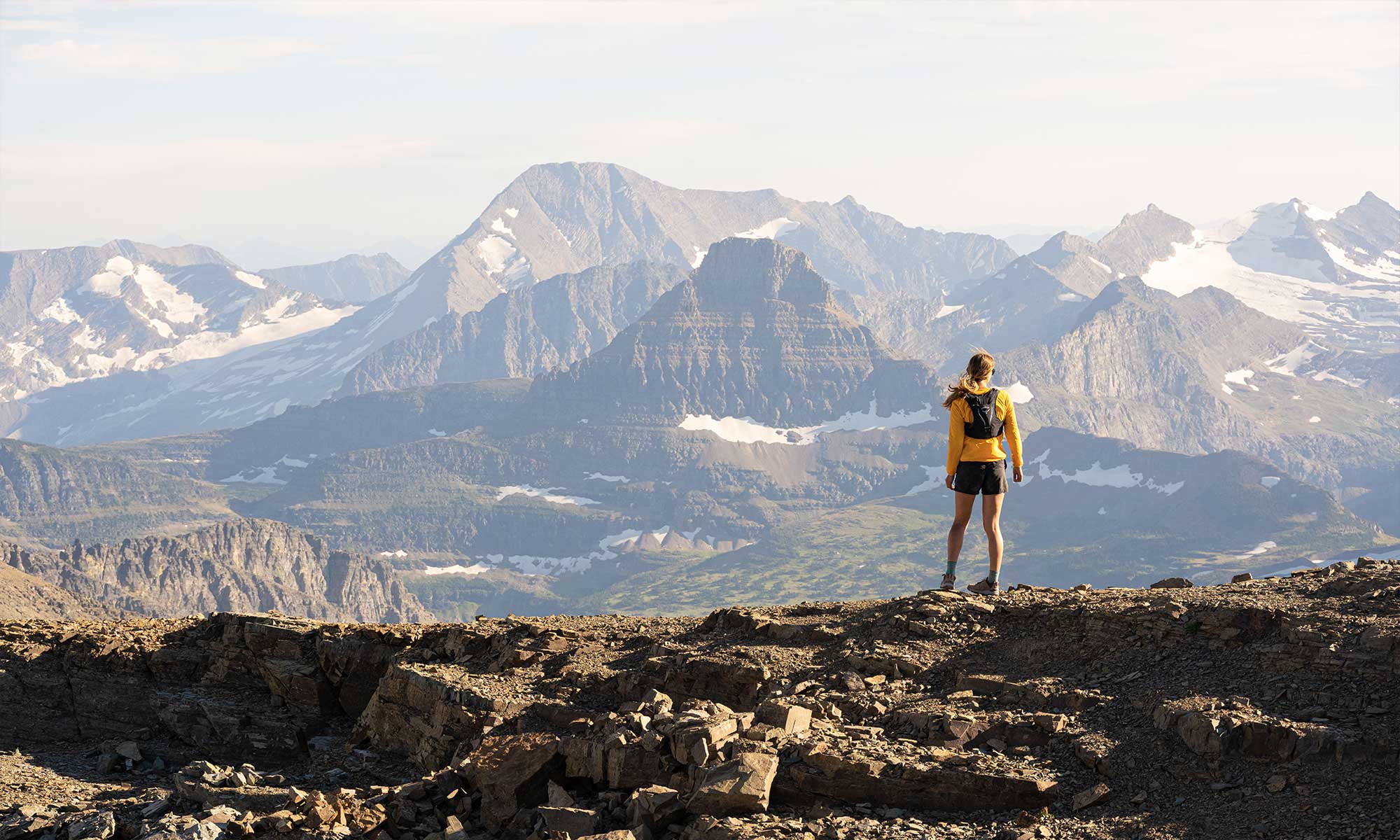 Woman backpacking in a gorgeous mountain landscape in Oboz Footwear.