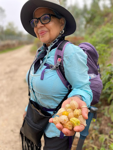 Karla Amador's mother holding fruit harvested alone the Camino de Santiago hiking trail.