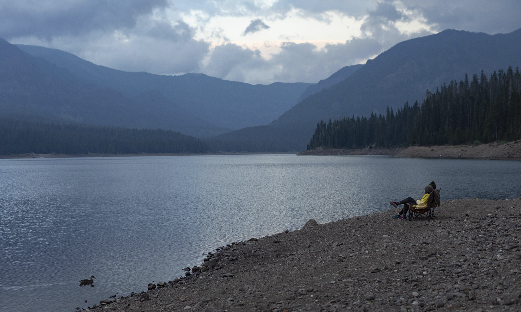 Two people enjoying the view at Hyalite lake near Bozeman, MT.