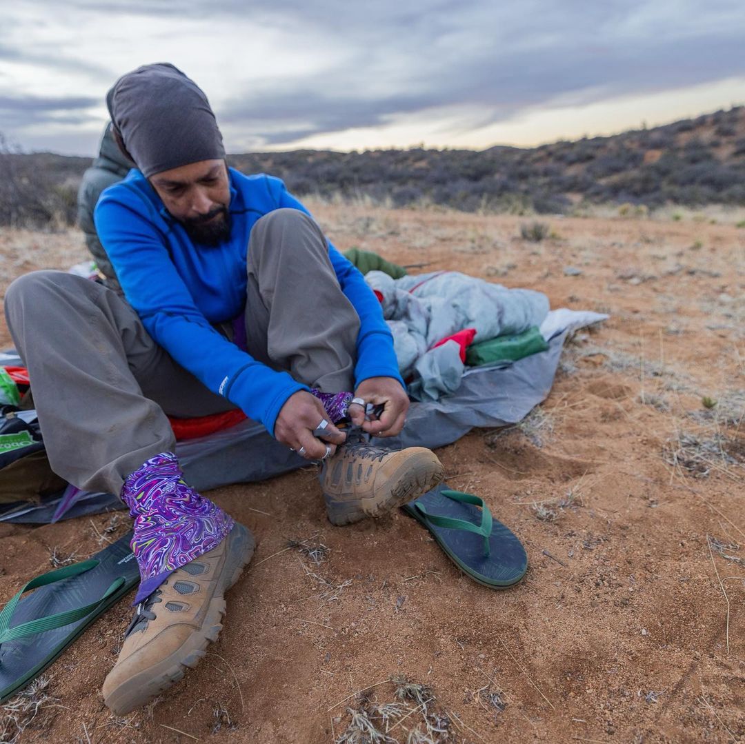 Derrick Lugo tying his Sawtooth X hiking boots.