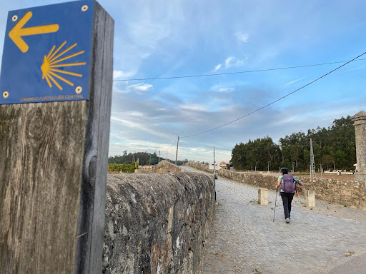 A hiker walks on the Camino thru hike wearing Oboz hiking shoes. 