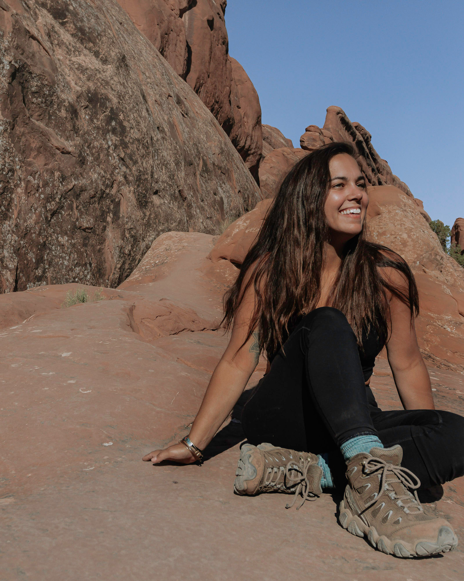 Woman wearing Oboz Sawtooth Mid hiking boots in Arches National Park.
