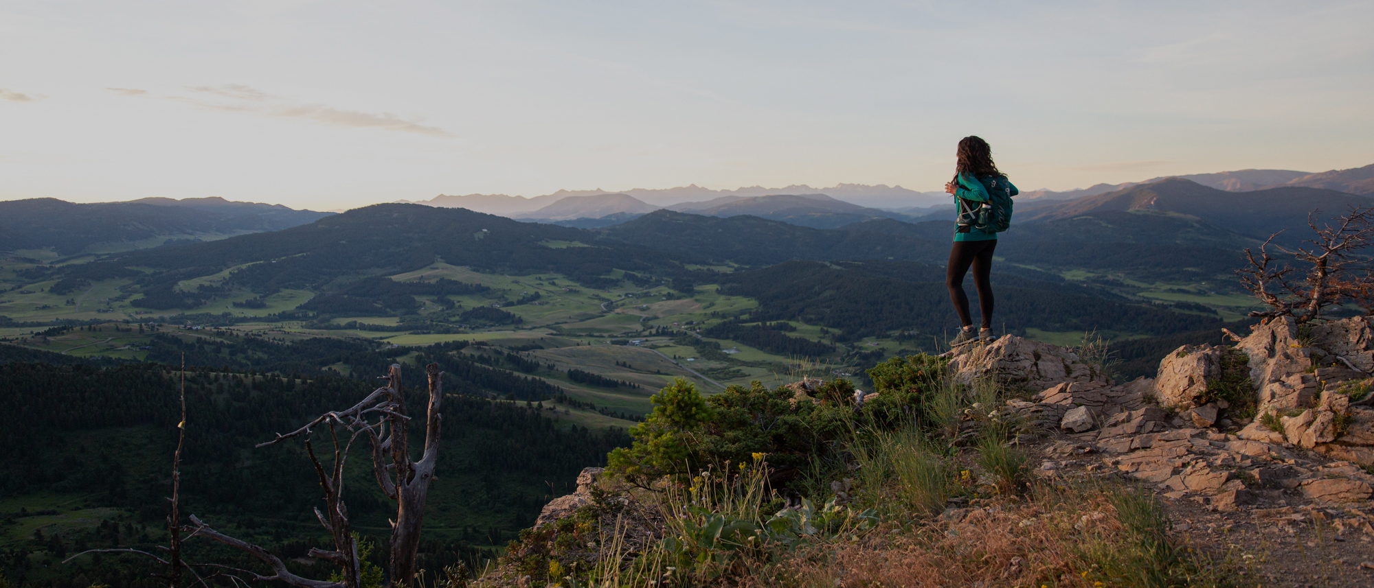 Jackie Nourse overlooking mountain views surrounding Bozeman, MT wearing Oboz hiking boots.