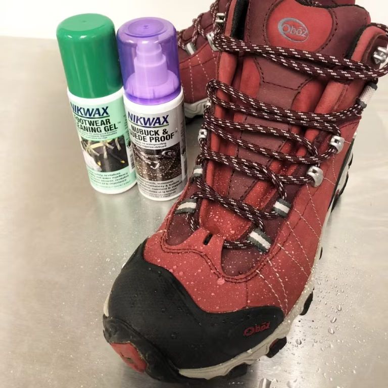 Oboz Bridger hiking boot with water droplets on it next to Nikwax Footwear Cleaning Gel and Nubuck & Suede Proof