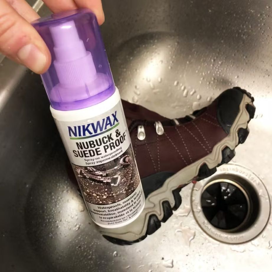Nikwax Nubuck & Suede Proof next to an Oboz Bridger boot being washed in a sink. 