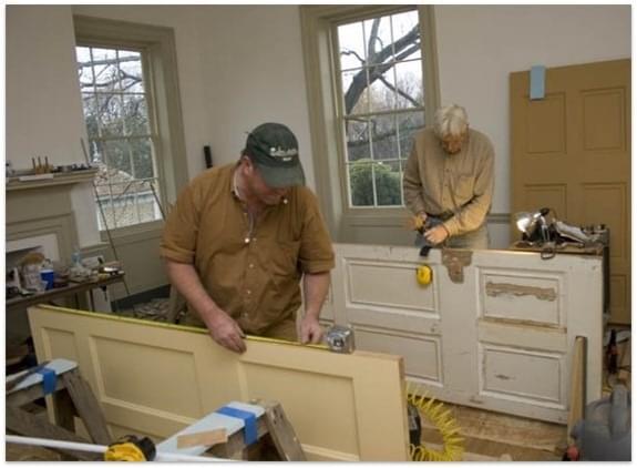 contractors manually sizing doors in a customers home