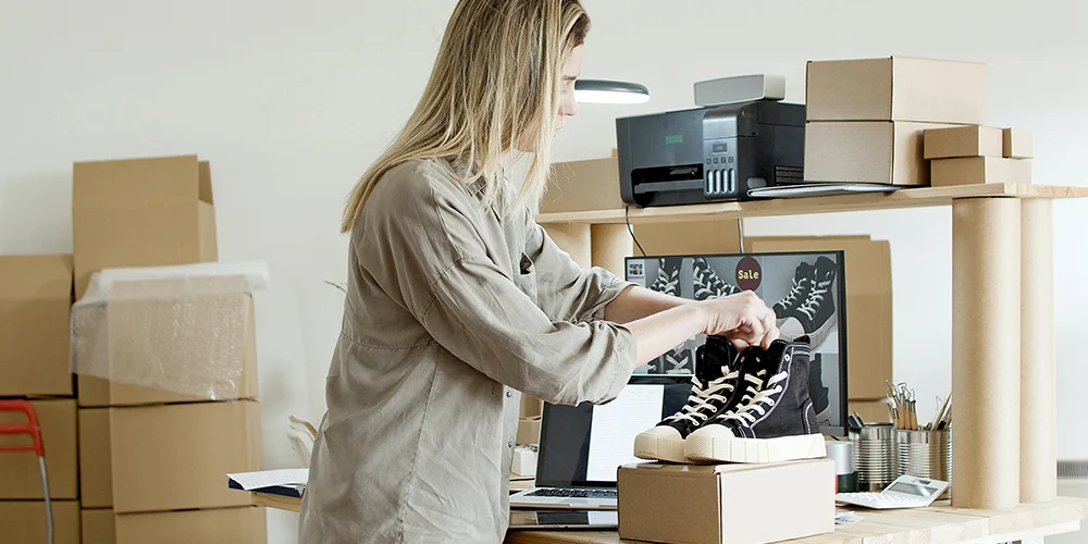 bir ayakkabı siparişini paketleyen kadın