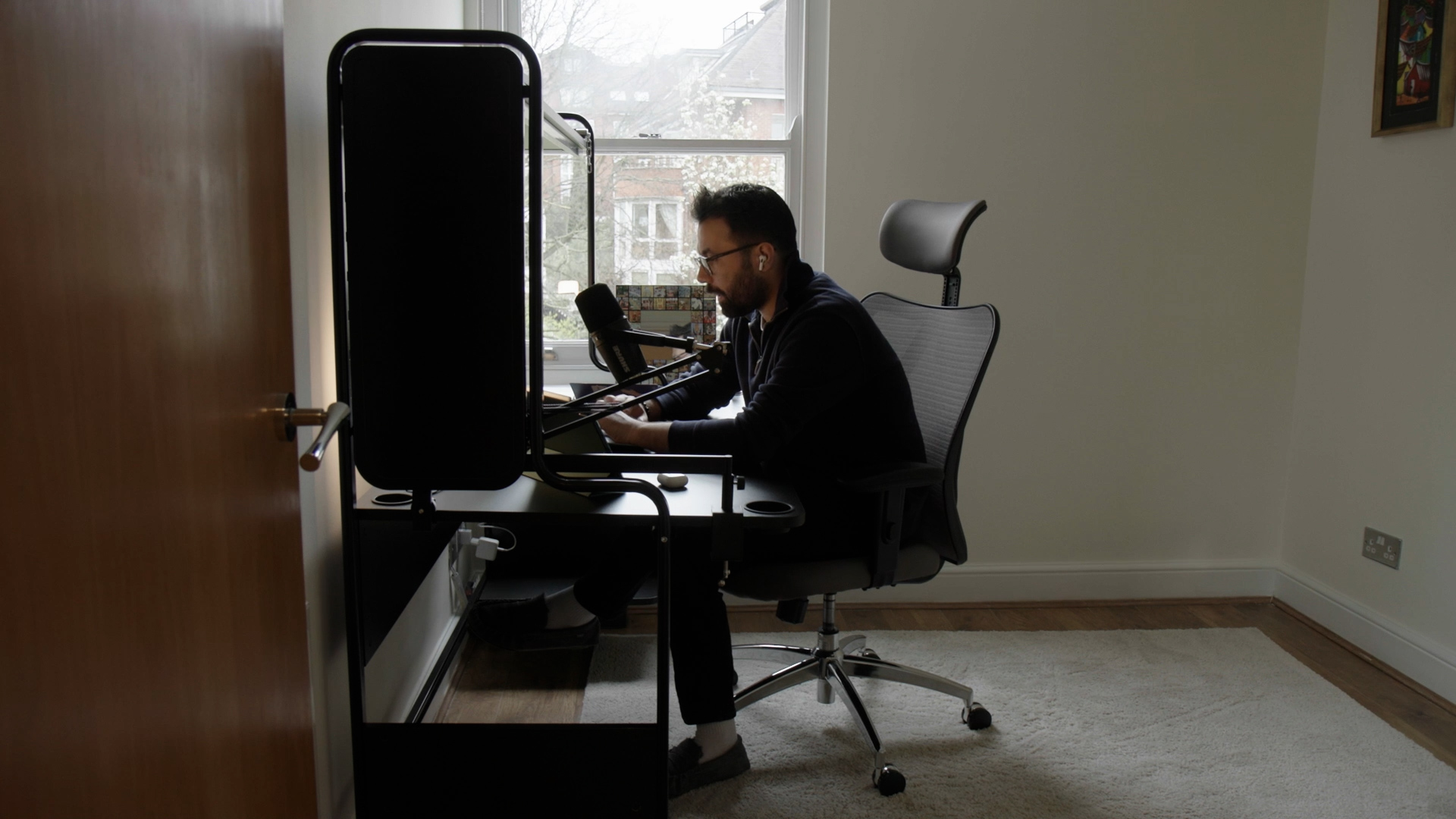 Osman working alone at his desk