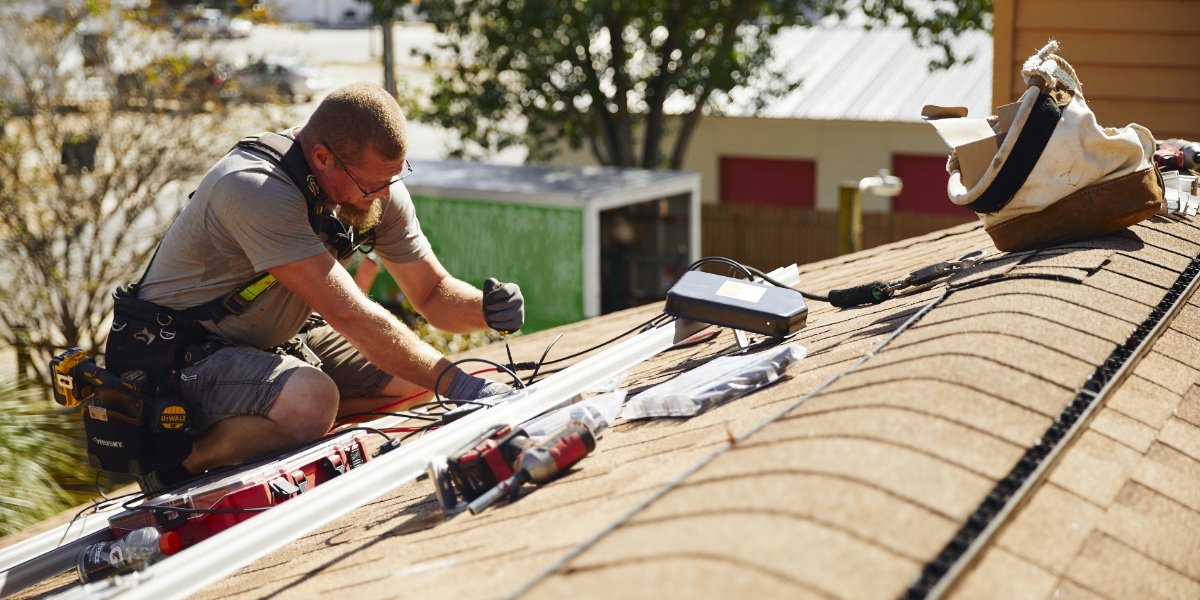 A solar service specialist works on the solar equipment of a company that has gone out of business and is no longer offering service, maintenance, or support.