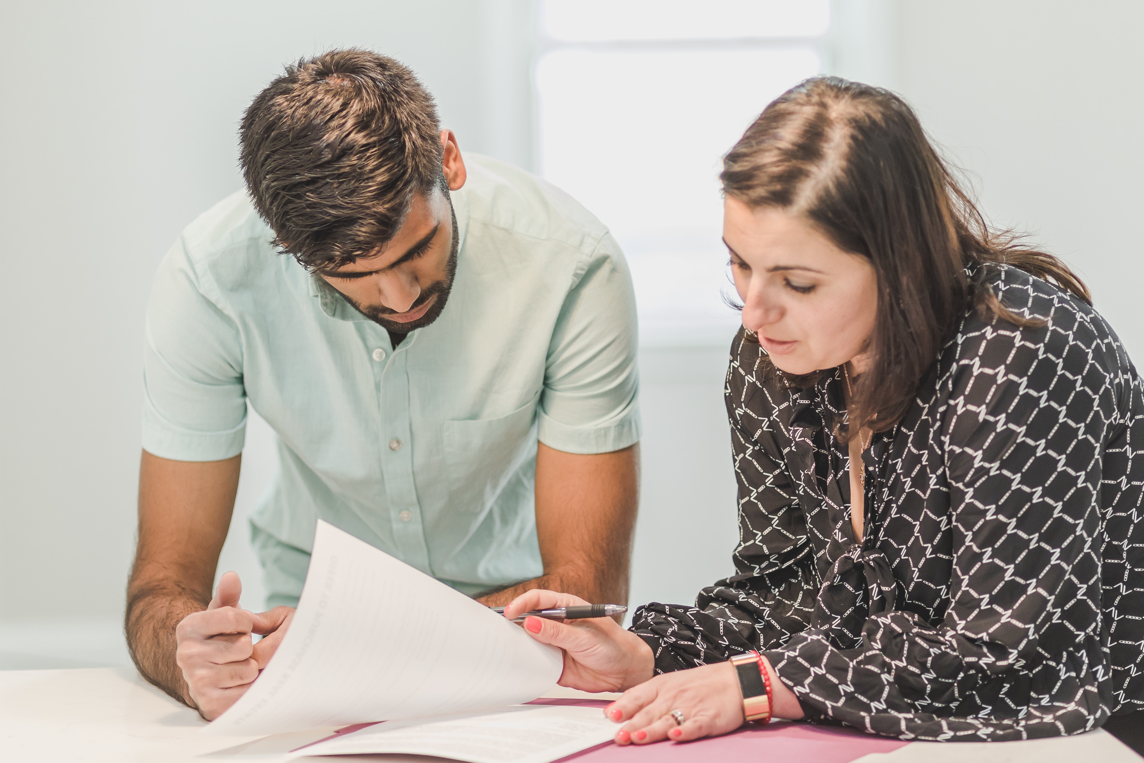Man and woman reviewing documents together at desk
