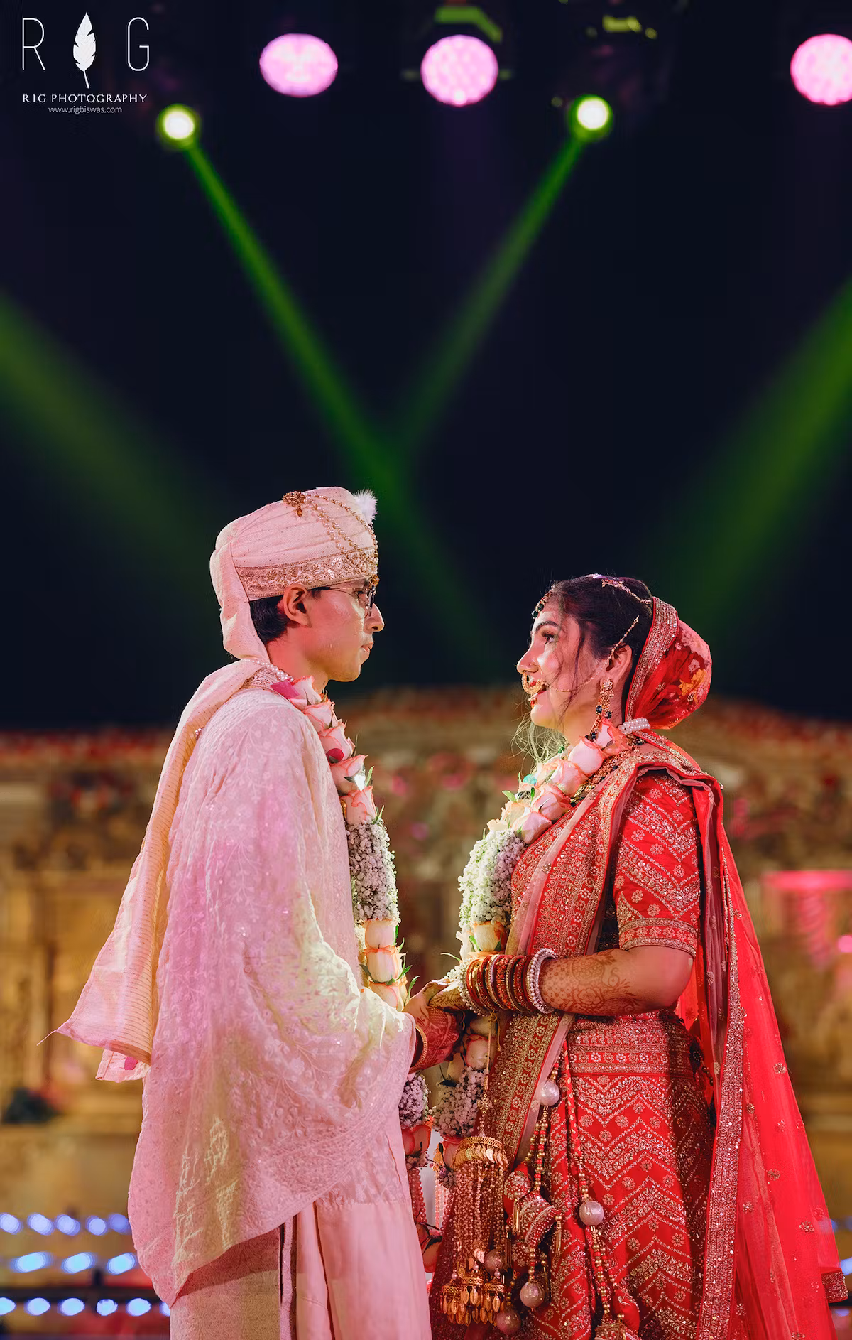Groom and bride exchanging jaimala on their wedding day as a symbol of vows