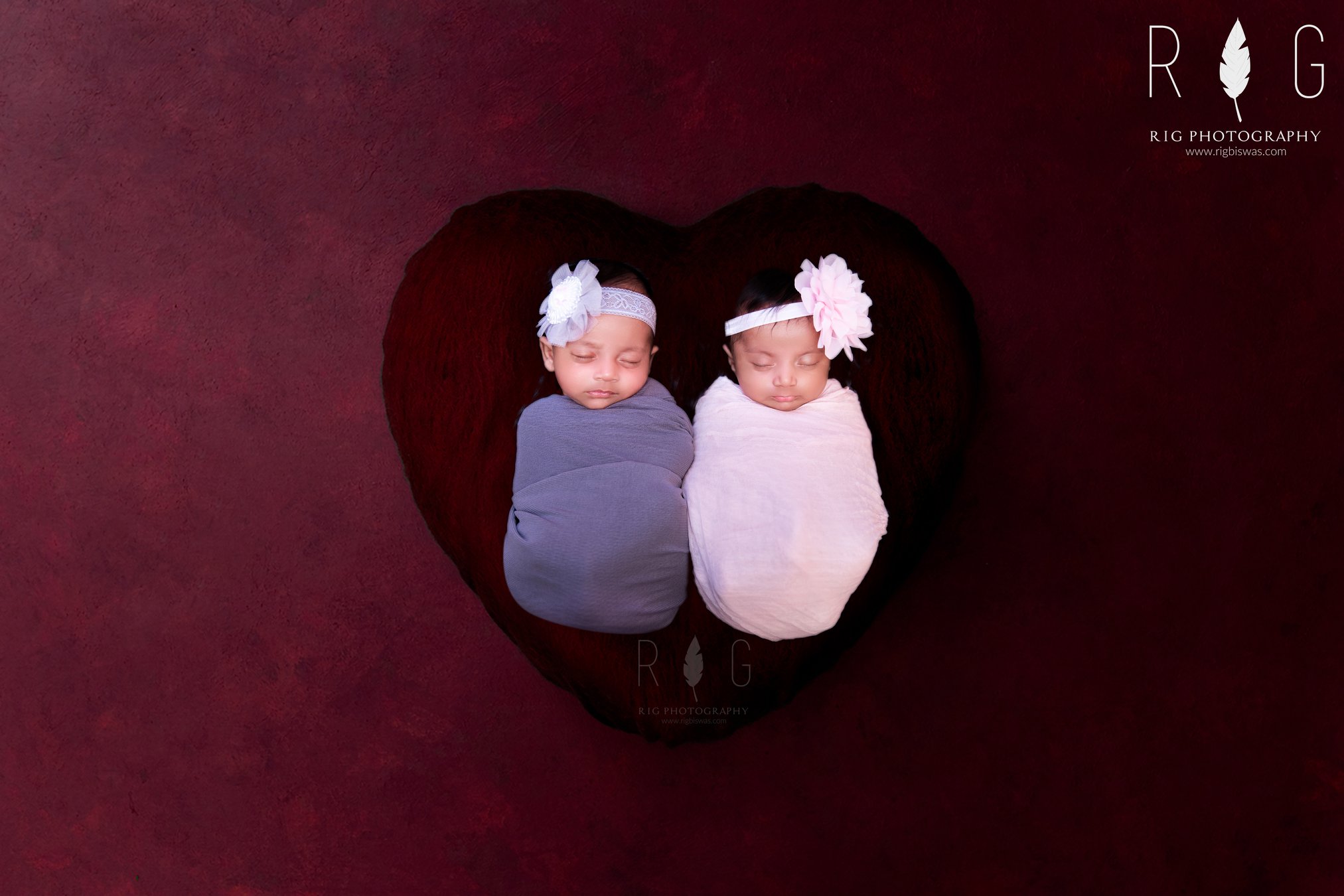 Image of twins kept on red heart cover