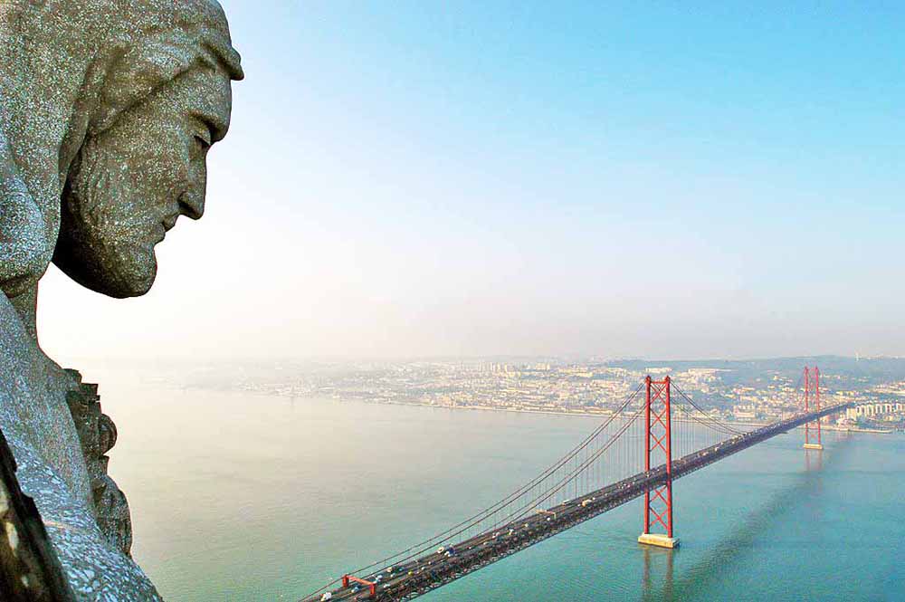 Christ the King overlooking the 25th of April bridge in Lisbon.