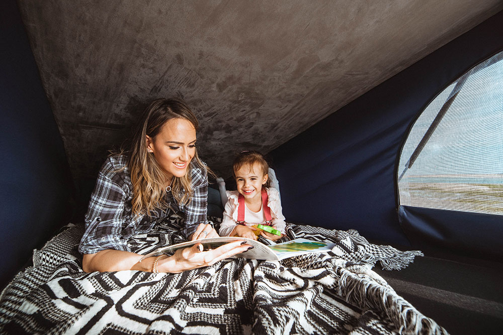 Mother and daughter family camping.