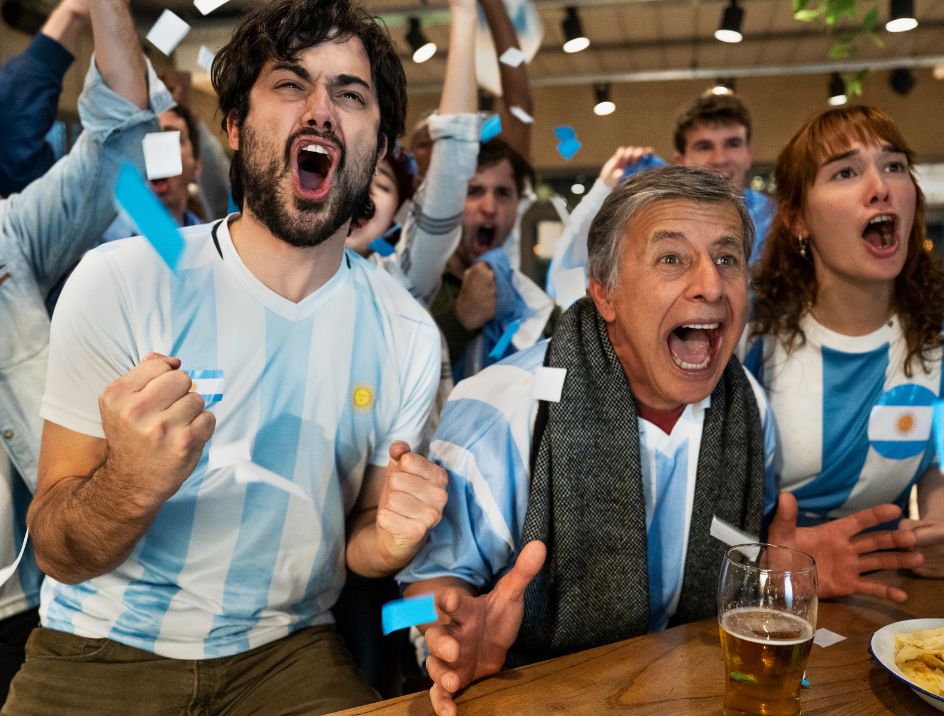 Devoted soccer fans for Argentina cheering on their favorite team at a bar