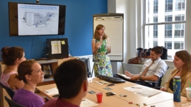 photo depicting a group of adult students listening to a powerpoint lecture