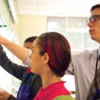 Photograph of Christopher H with students