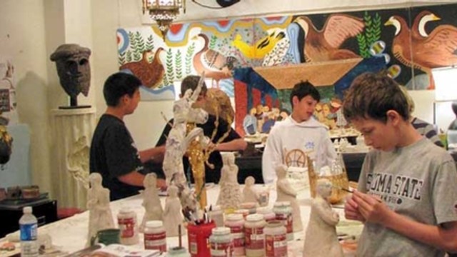 group of students working on arts and crafts in a classroom setting