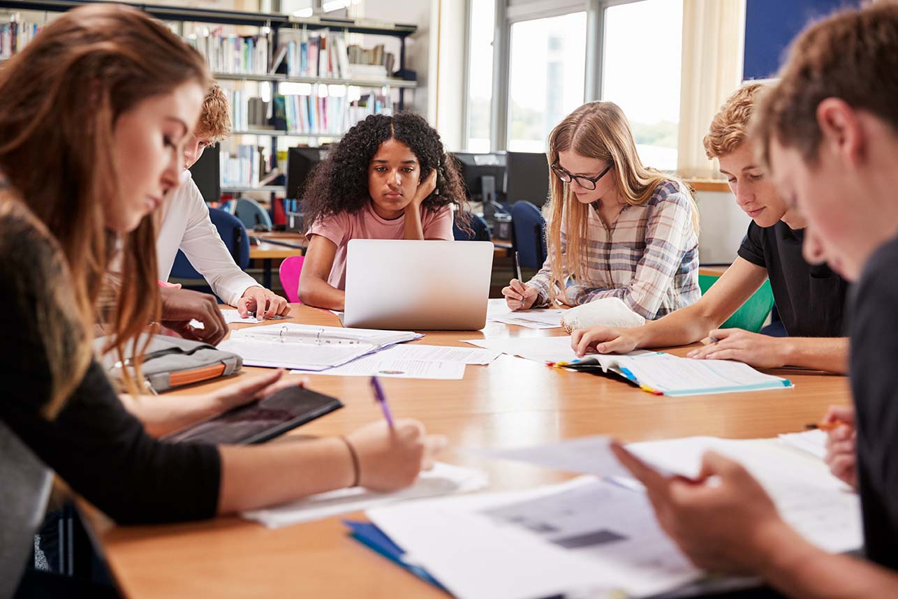 Group Of College Students Working Around Table